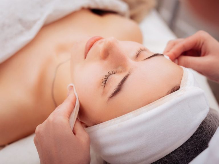 Beauty Rituals in Marbella Woman receiving a facial treatment in the comfort of her home in Marbella