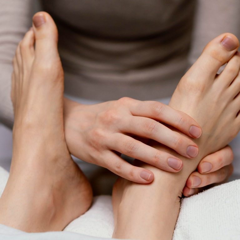 Luxury Home Massage Marbella A woman relaxing by a swimming pool, wearing a hat and a summer dress, waiting for her SENSE8 home massage