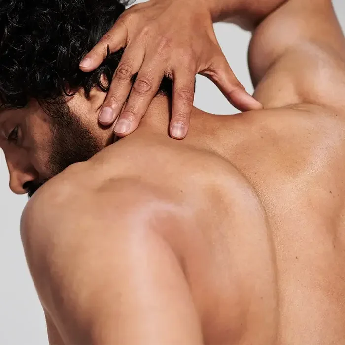 Home Massage Marbella Relaxing massage on the back of a person with hands on the skin.